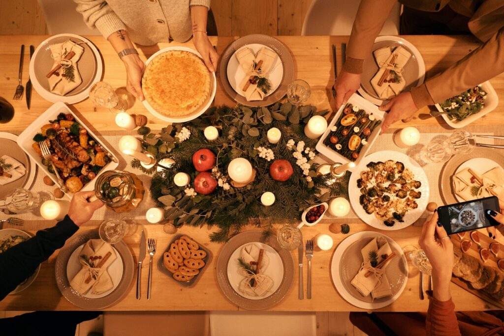 table set for holiday meal with an evergreen centerpiece and healthy options for staying fit